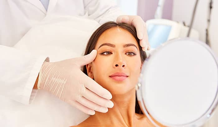 Middle aged lady receiving skin consultation in Ruthin